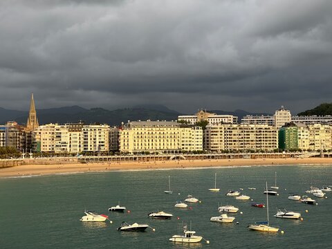 Coastal town San Sebastian with beach and boats in La Concha Bay, Basque Country, Spain, July 2023