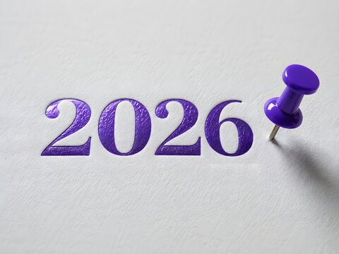 Purple twenty twenty six date stamped on white paper with matching push pin tool.