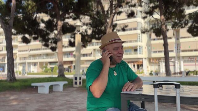 Hombre con maleta hablando por tel&eacute;fono en Altea
