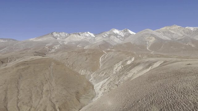 Drone shot of scenic himalayan terrain showcasing the mountains of Upper Mustang, Nepal, perfect for adventure, overlanding, tourism, documentary projects, vlogs