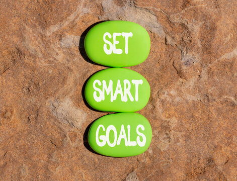 Set smart goals words symbol. Concept words Set smart goals on beautiful green stones. Beautiful stone beach background. Business and set smart goals concept. Copy space.