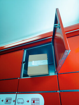 Vertical Angle of Cardboard Box Inside Open Parcel Locker Door
