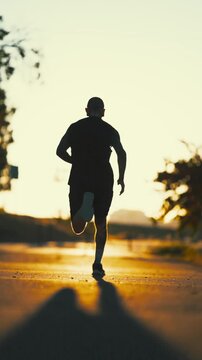 Silhouette of a man running during sunset workout