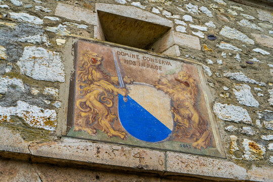 Domine conserva nos in pace - lat. - Lord, keep us in peace. Ancient Painted Coat of Arms with Two Lions on a Stone Wall in Old Town Nyon, Switzerland - June 23, 2026