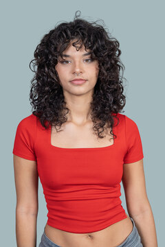Young woman confidently showing her curly hair and septum piercing