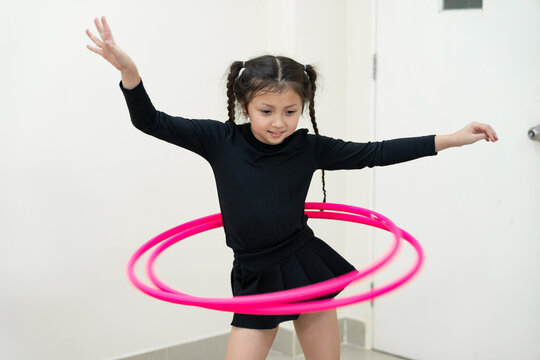 Kid girl playing Hula hoop