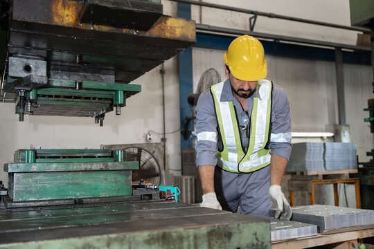 Industrial workers working and control machine at auto parts factory