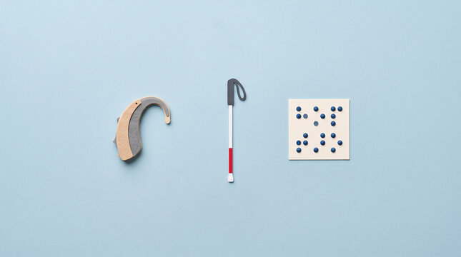 Minimalist representation representing hearing impairment visual disability and sensory aid tools for diverse inclusive communication with braille square solid light blue background