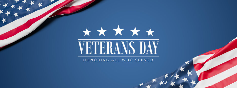 Two wrinkled flags of the USA draped onto a flat dark blue surface and the text "Veterans Day - Honoring all who served" - web banner format