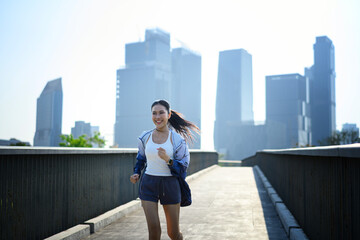 Fototapeta premium Joyful runner in city sunlight, active urban lifestyle momentum.