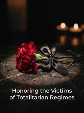 Red rose and black ribbon with candles honoring totalitarian victims