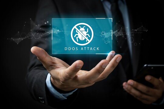 Person in a suit displays a digital interface warning of a ddos attack with a bug icon.