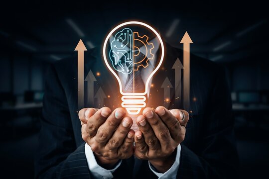Person in a suit holds a glowing lightbulb containing a brain and gears, with upward arrows symbolizing growth.