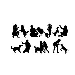 Obraz premium Silhouettes of people and dogs playing together