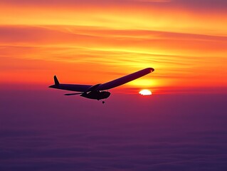 Glider Aircraft Silhouette Flying Against a Vibrant Sunset Over Clouds