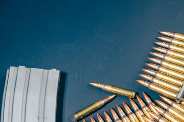 Rifle ammunition bullets on stripper clips with weapon background. Real photograph, not AI-generated © TimeStopper