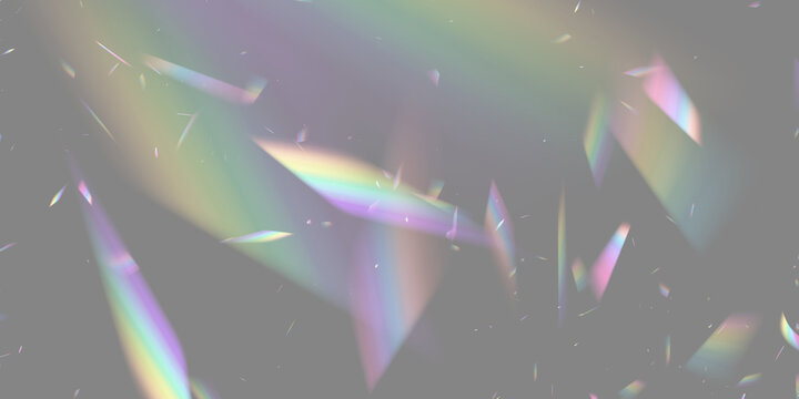 Multicolored prism fragments casting soft rainbows on a dark background with scattered light streaks on transparent background
