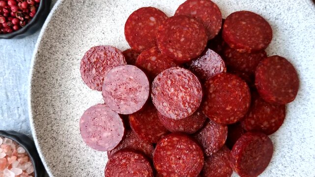 Slices of smoked pepperoni or salami for making homemade pizza. Sliced pepperoni as a food background for your design