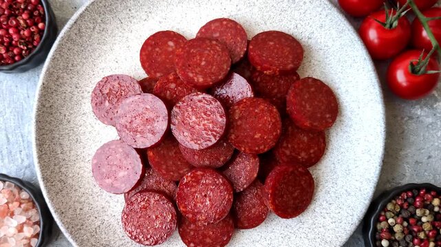 Slices of smoked pepperoni or salami for making homemade pizza. Sliced pepperoni as a food background for your design