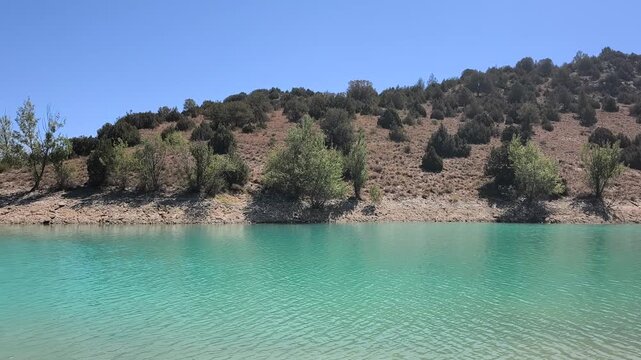 Panoramic view of the Teruel reservoir in spain with its turquoise waters on a blue sky day