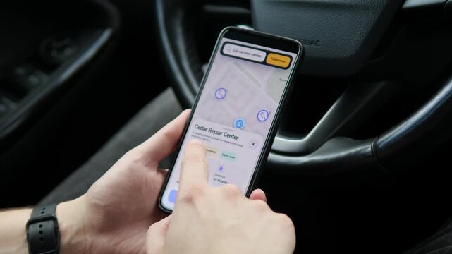 Driver searches a mobile map for a nearby car repair center, compares ratings and reads customer reviews, highlighting location services, vehicle maintenance and informed consumer choice.