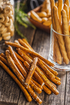Salted Pretzel Sticks On Rustic Wooden Table With Glass Jar And Warm Lighting