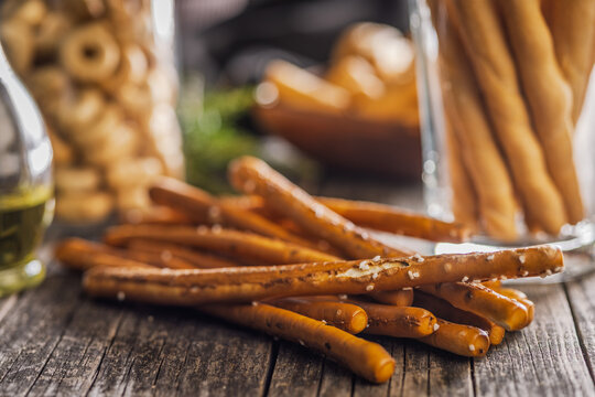 Salted Pretzel Sticks On Rustic Wooden Table With Glass Jar And Warm Lighting