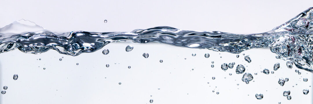 Pure water splash wave with underwater bubbles background. Real photograph, not AI-generated