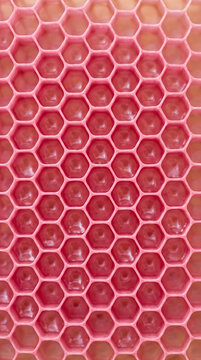 Hexagonal honeycomb cells inside beehive with natural wax texture details