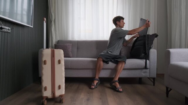 Modern transient lifestyle and temporary living. Man working and moving between rented apartments with constant relocation