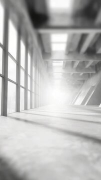 Spacious corridor interior with sunlight streaming through expansive windows, casting dramatic shadows on the floor. The clean, modern design emphasizes openness and contemporary style