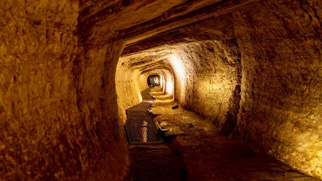 Pythagoreio, Greece - August 1, 2026: View of the Tunnel of Eupalinos on Samos Island, showing the ancient underground aqueduct passage, stone walls, narrow corridor, archaeological site details