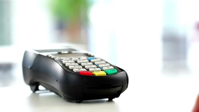 Credit card payment on modern terminal for retail store purchase to buy and sell shopping products and consumer services in 4K Ultra HD footage
