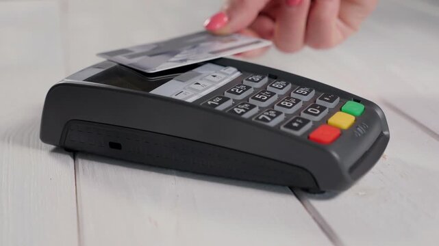 Female hands holding credit card and navigating secure electronic bank terminal for fast retail payment transaction in 4K Ultra HD footage
