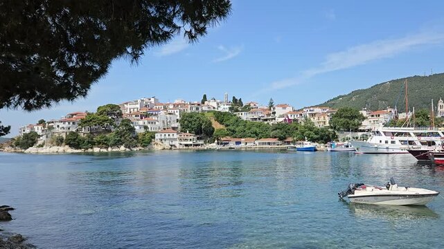 Skiathos Town old port waterfront with moored tourist excursion boats and Greek architecture, Skiathos Island, Greece