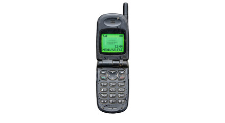 Old flip phone covered in dirt and grime, showing a green screen display