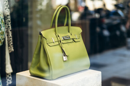 Nice, France - July 27, 2026: Green Hermes Birkin handbag displayed in the window of a vintage boutique on Avenue de Suede