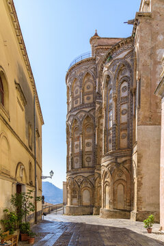 Monreale Cathedral apses along a historic street in Sicily, Italy