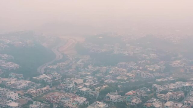 A panoramic view of the houses in a city completely polluted by smog, a serious consequence of climate change.