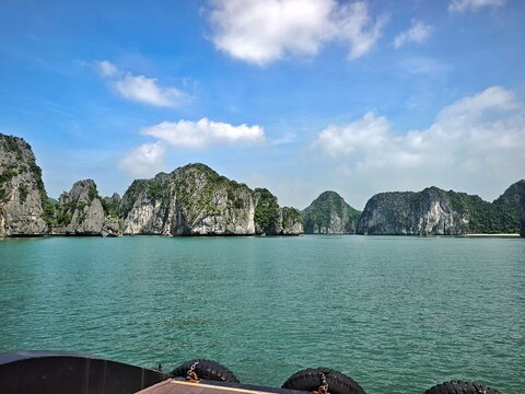 Lan Ha Bay, Haiphong City, Vietnam. The bay is recognized by UNESCO as a natural world heritage site, with limestone mountains formed millions of years ago, and vegetation, surrounding a bay in a trop