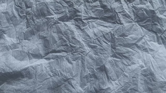 Crumpled paper texture changing stop motion background loop.