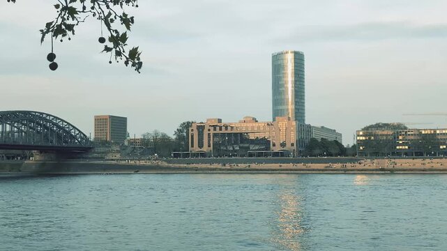 Explore the embankment in Cologne with its modern buildings and river views at sunset