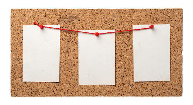 Three blank notes pinned to a corkboard with red string and pins