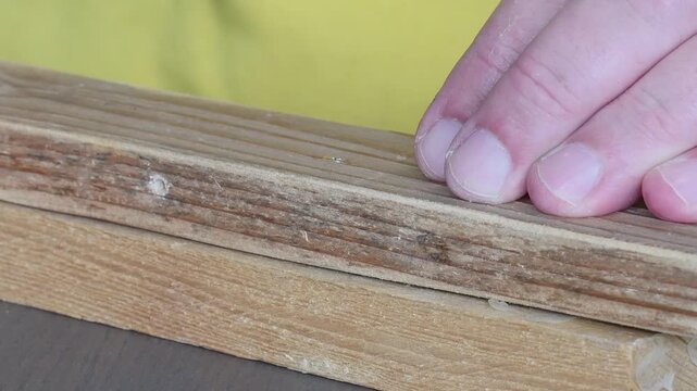 Removing a screw from wood with an electric screwdriver for woodworking projects