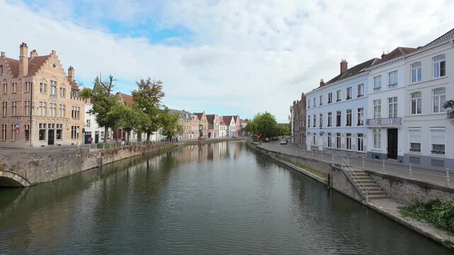 Static view over canal from bridge in historic center of Bruges, Belgium, morning light