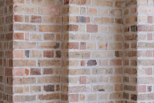 Weathered brick wall texture with varied tones and mortar pattern.