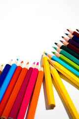 Obraz premium Colored pencils isolated on white background. Equipment for coloring. Stationery for creativity.Back to school. Flatlay. Children's Creativity and Education background texture. Rainbow.