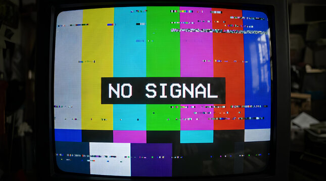 Vintage television set displaying color bars and no signal.