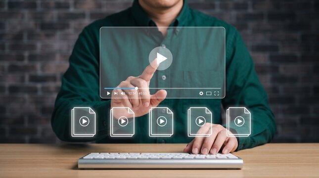 Person interacting with a virtual video player interface and digital media file icons on a desk