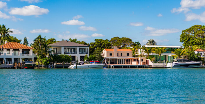 Luxury waterfront house. Hotel building architecture. Residential architecture. Vacation building in summer at the river. Luxury boat motor yacht in marina. Luxury yacht. Luxurious lifestyle